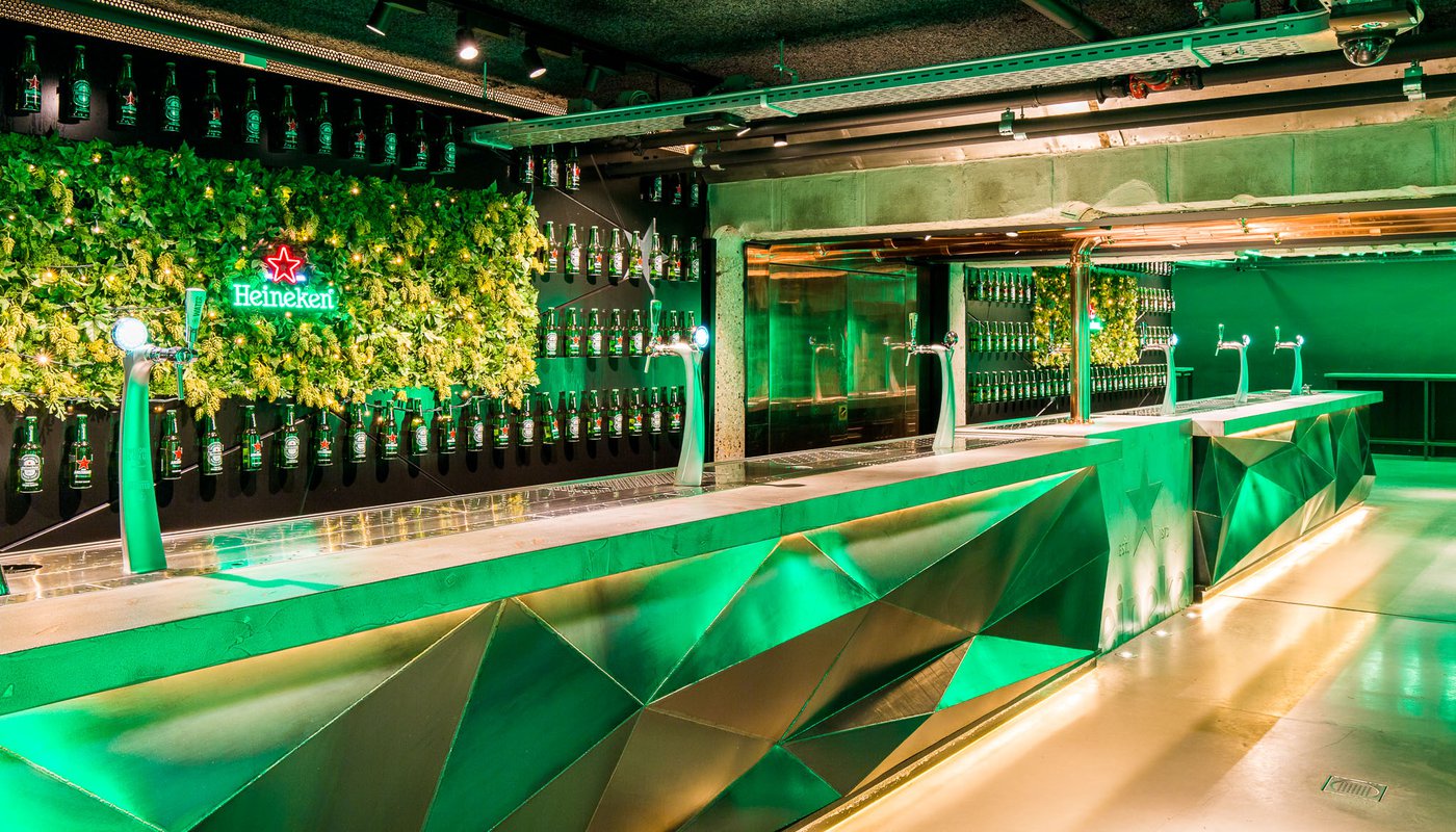 Nightclub-style, green-tinged bar at Heineken’s Amsterdam brewery