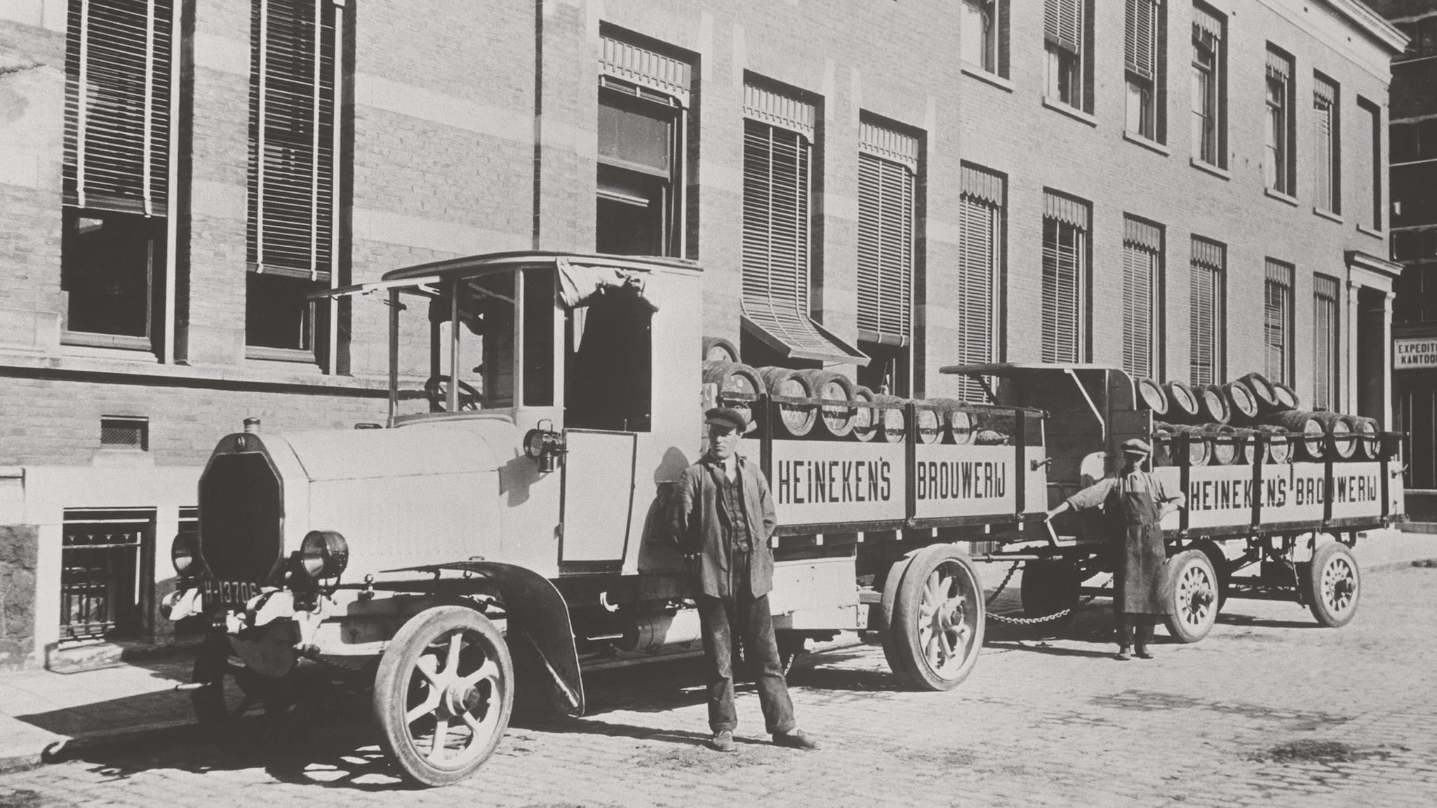 Heineken employees fill trucks with barrels of beer in 1864